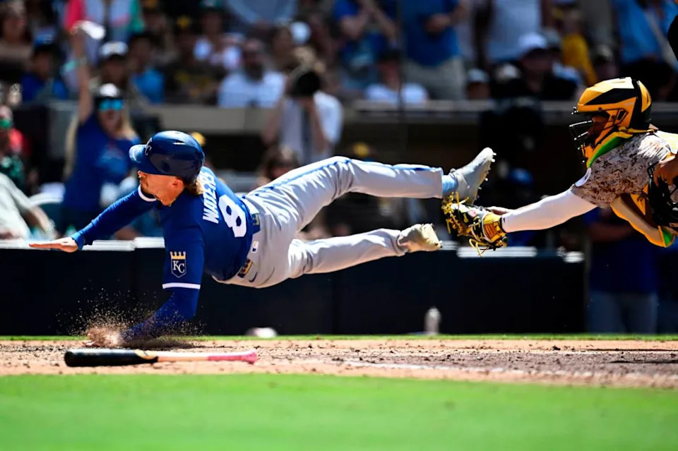 Kansas City Royals outfielder Drew Waters, left, was called out at home plate while trying to score around the tag of Padres catcher Martín Maldonado during the ninth inning of a Sunday, June 22, 2025 Major League Baseball game at Petco Park in San Diego.