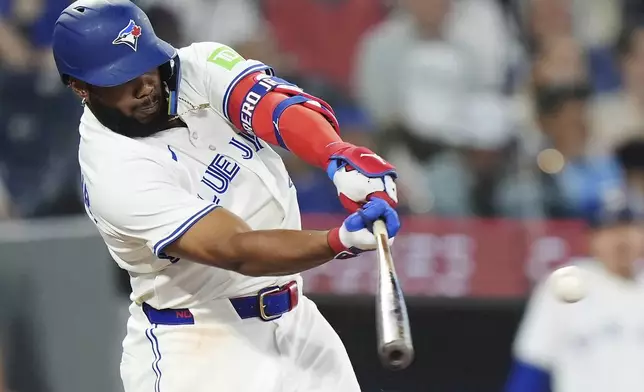 Toronto Blue Jays' Vladimir Guerrero Jr. (27) hits a two-run double against the Arizona Diamondbacks during the sixth inning of a baseball game in Toronto, Wednesday, June 18, 2025. (Frank Gunn/The Canadian Press via AP)