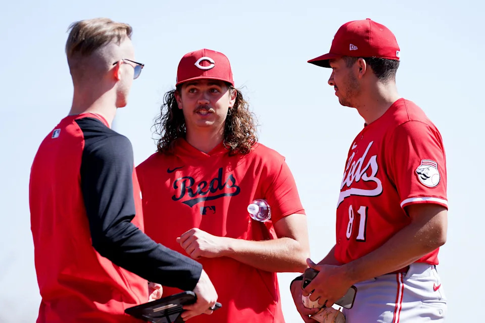 Chase Burns, right, talks with fellow Wake Forest product Rhett Lowder, center, in spring training. Burns, 22, has dominated at three minor-league levels this season, going 7-3 with a 1.77 ERA and 89 strikeouts in 66 innings across those 13 starts.