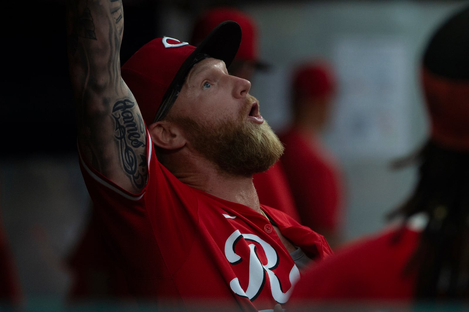 Cincinnati Reds' Jake Fraley jokes around in the dugout before the eighth inning of a baseball game against the Cleveland Guardians, Tuesday, June 10, 2025, in Cleveland. (AP Photo/Phil Long)