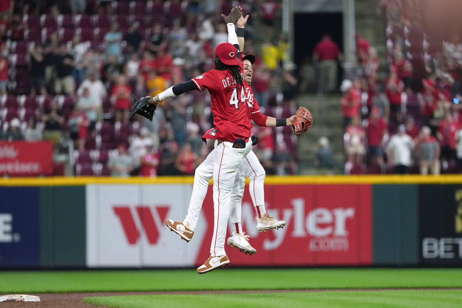 Cincinnati Reds' Elly De La Cruz, left, and TJ Friedl, right, celebrate at the conclusion of a baseball game against the Milwaukee Brewers, Tuesday, June 3, 2025, in Cincinnati. (AP Photo/Kareem Elgazzar)