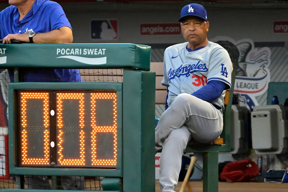 Los Angeles Dodgers manager Dave Roberts (30) looks on from the dugout against the Los Angeles Angels at Angel Stadium.Jayne Kamin-Oncea-Imagn Images