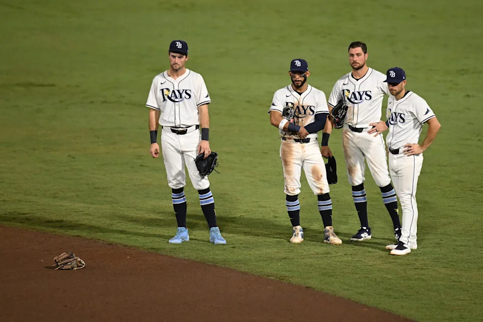 A group of Tampa Bay Rays players look as pitcher Hunter Bigge (43) gets medical attention after getting hit in the face by a foul ball.