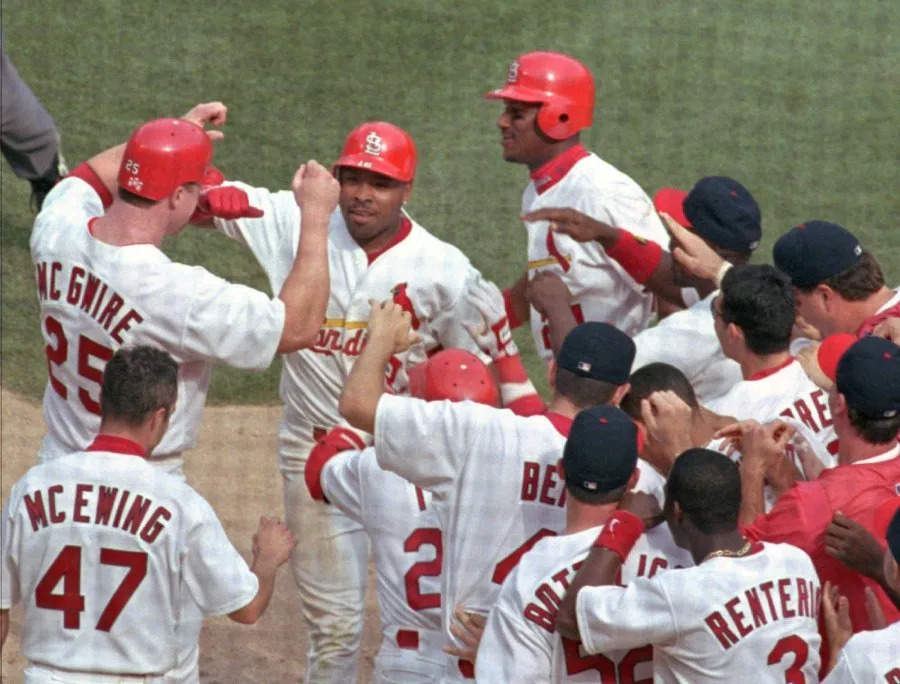 St. Louis Cardinals’ Ray Lankford is congratulated by teammate Mark McGwire (25) and other Cardinals after hitting the game- winning two-run home run in the ninth inning against the Los Angeles Dodgers, Sunday, May 16, 1999 at Busch Stadium in St. Louis. McGwire also scored on the play. The Cardinals won 5-4. (AP Photo/Tom Gannam)