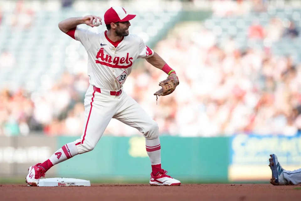 Angels second baseman Chris Taylor throws to first base after forcing out a Mariners runner.