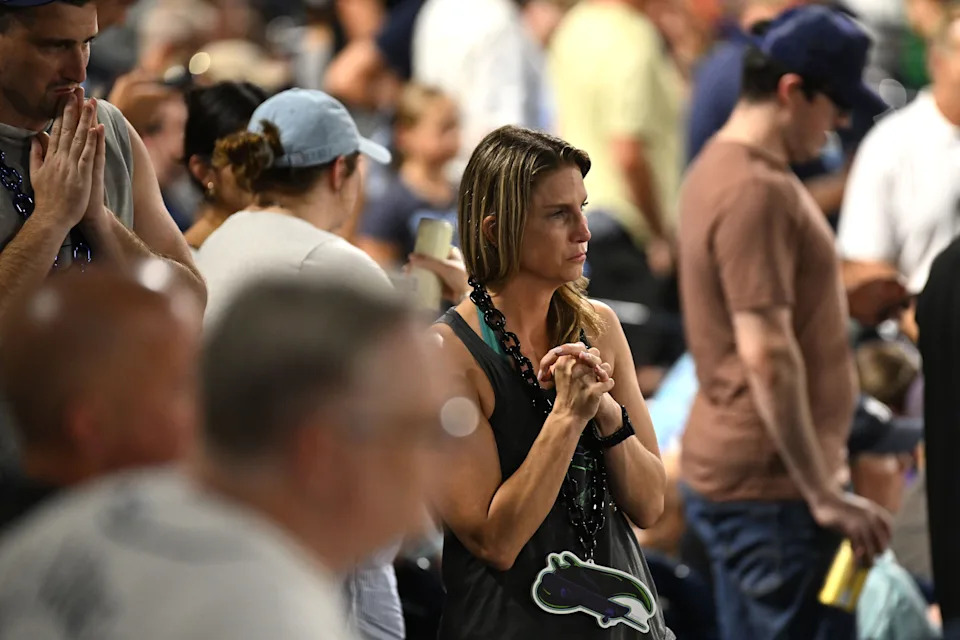 Tampa Bay Rays fans look on as pitcher Hunter Bigge (43) gets medical attention after getting hit in the face by a foul ball in the seventh inning.