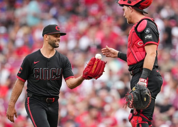 Cincinnati Reds pitcher Nick Martinez, left, speaks with catcher Tyler Stephenson at the pitcher's mound during the third inning of a baseball game against the San Diego Padres, Friday, June 27, 2025, in Cincinnati. (AP Photo/Jeff Dean)