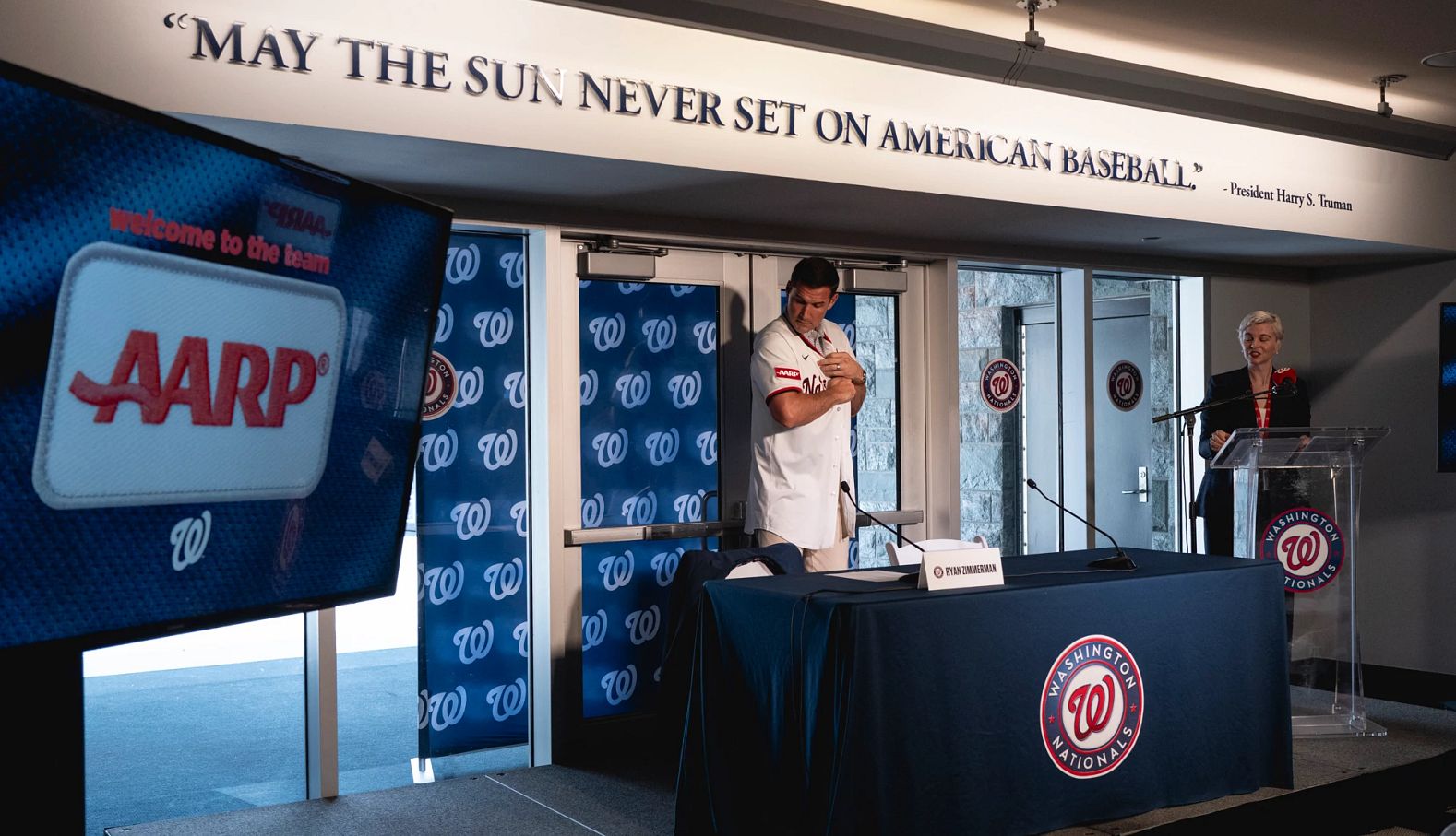 ryan zimmerman showing the a a r p patch on the washington nationals jersey at a press conference