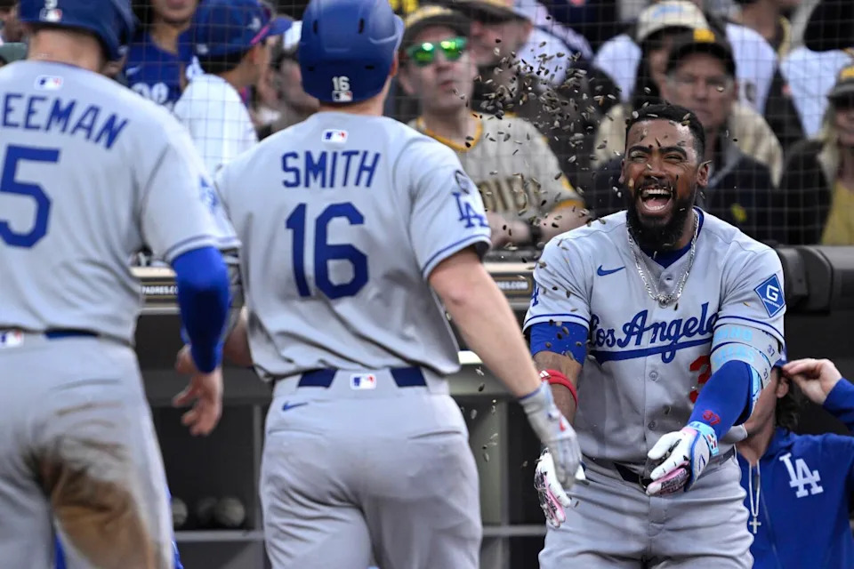 Los Angeles Dodgers' Will Smith (16) has sunflower seeds tossed at him by Teoscar Hernandez.