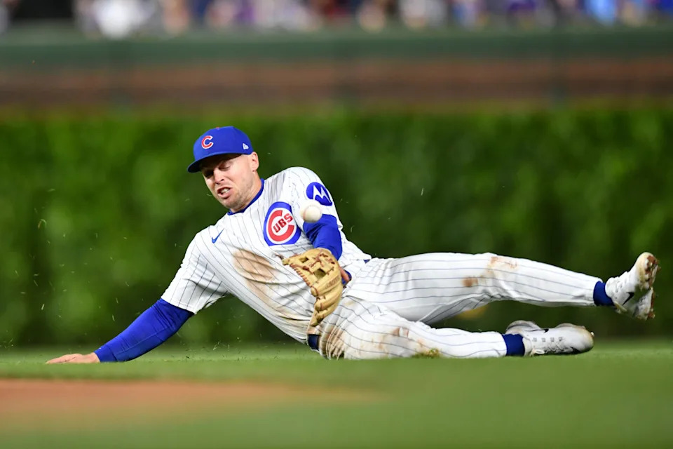 Chicago Cubs second baseman Nico Hoerner (2) attempts to field a ground ball during the seventh inning against the Colorado Rockies at Wrigley Field.Patrick Gorski-Imagn Images