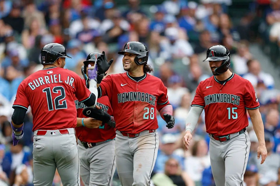 Arizona Diamondbacks third baseman Eugenio Suarez (28) celebrates with teammates after hitting a grand slam against the Chicago Cubs during the eighth inning at Wrigley Field in Chicago on April 18, 2025.