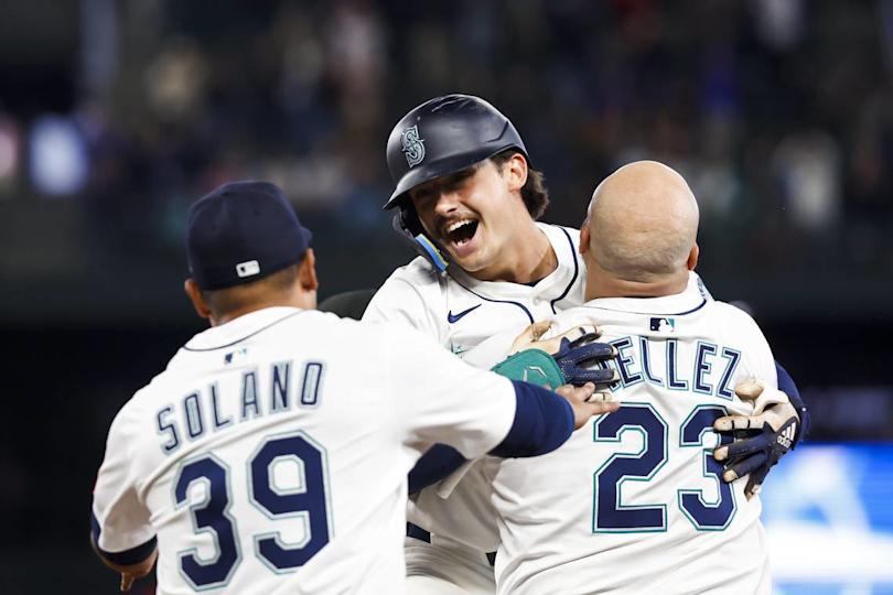 May 31, 2025; Seattle, Washington, USA; Seattle Mariners second baseman Cole Young (2, middle) celebrates with first baseman Rowdy Tellez (23) and infielder Donovan Solano (39) following a walk-off RBI-fielders choice against the Minnesota Twins during the eleventh inning at T-Mobile Park. Joe Nicholson/USA TODAY NETWORK