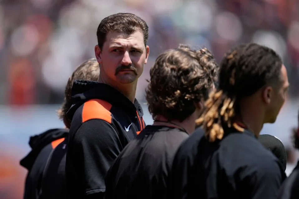 San Francisco Giants pitcher Sean Hjelle, facing, stands with teammates during the national anthem before a baseball game against the Boston Red Sox in San Francisco, Sunday, June 22, 2025. AP