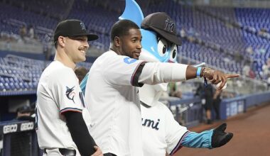 Miami Dolphins tight end Jonnu Smith (center) and the Marlins' Janson Junk are seen at the near-empty game