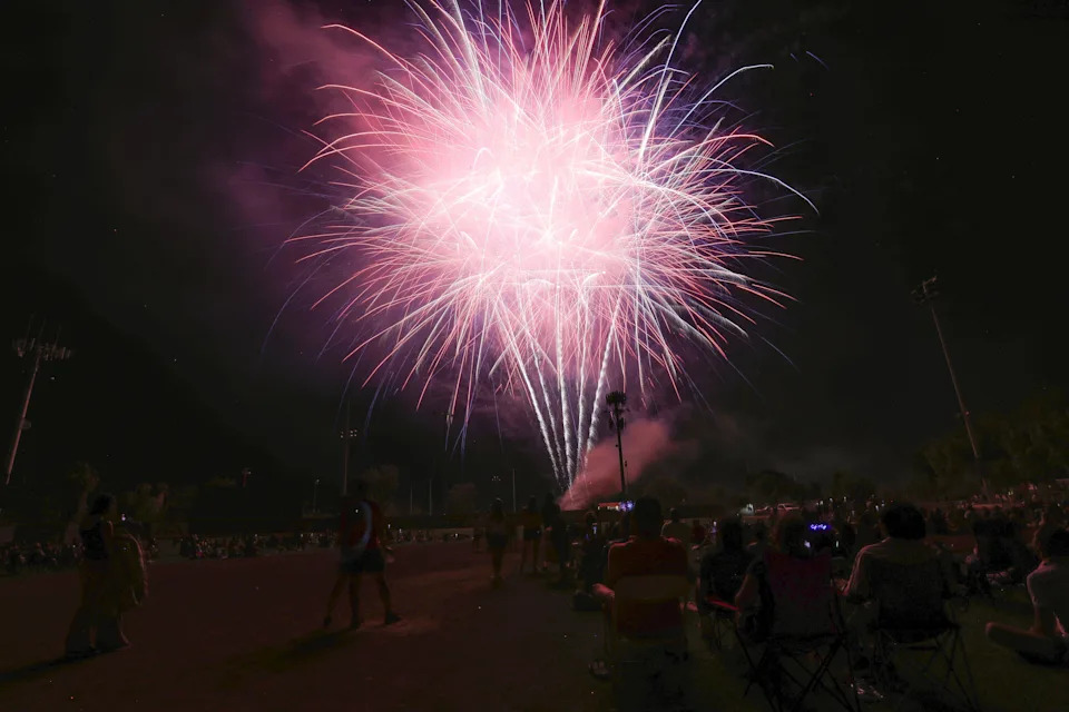 People watch the fireworks display on the field of play at the Palm Springs Stadium on the Fourth of July right after a Palm Springs Power baseball game in Palm Springs, Calif., July 4, 2024.