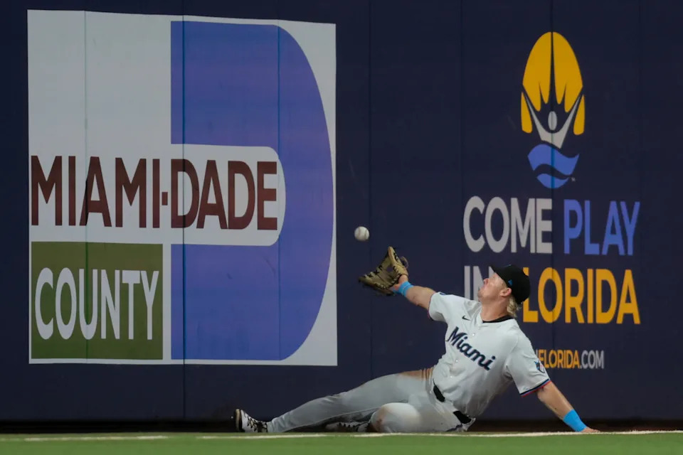 Miami Marlins right fielder Kyle Stowers (28) makes a diving catch to retire Colorado Rockies right fielder Mickey Moniak (not pictured) during the seventh inning at loanDepot Park. Sam Navarro-Imagn Images