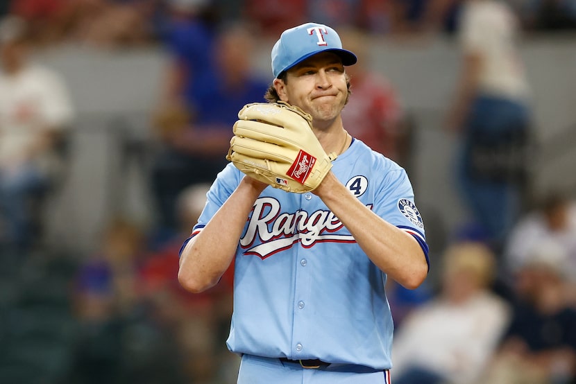 Texas Rangers starting pitcher Jacob deGrom (48) reacts after giving up a run during the...
