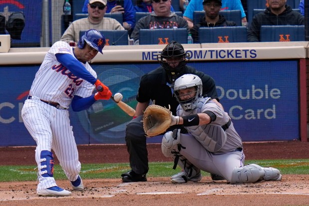 New York Mets' Juan Soto, left, bats during the first inning of a baseball game against the Colorado Rockies, Sunday, June 1, 2025, in New York. (AP Photo/Seth Wenig)