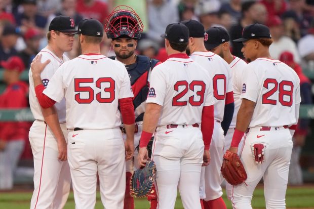 Boston Red Sox starting pitcher Richard Fitts, left, listens to...