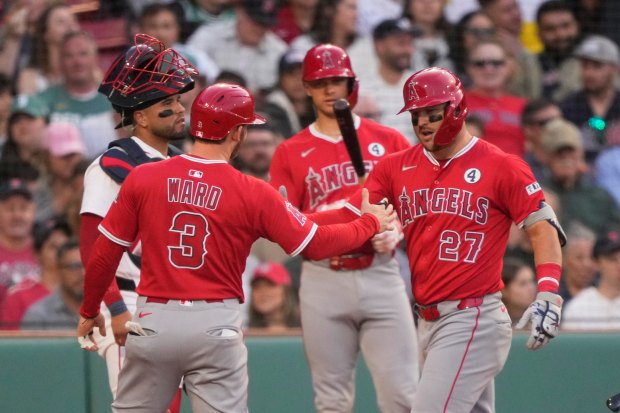 Angels star Mike Trout, right, is congratulated by Taylor Ward,...