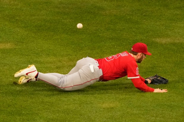 Angels left fielder Taylor Ward can’t make the play on...