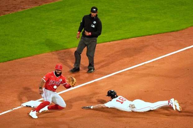 The Boston Red Sox’s Jarren Duran slides into third base...