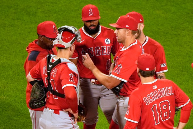 Angels starting pitcher Tyler Anderson hands over the ball after...