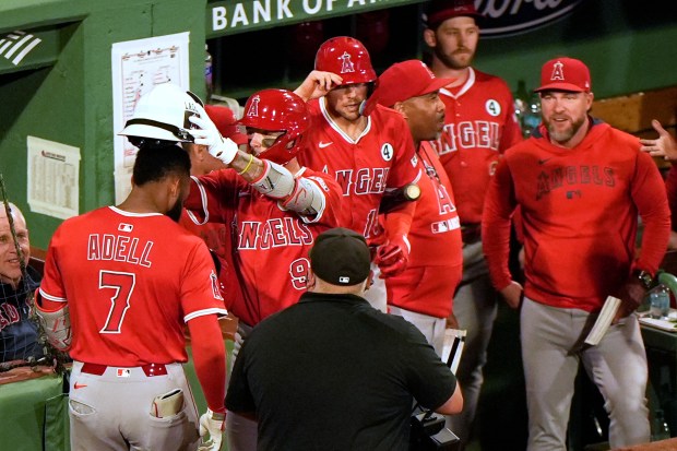 The Angels’ Jo Adell (7) has the fire fighter helmet...