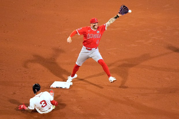Angels shortstop Zach Neto catches the ball for a force...