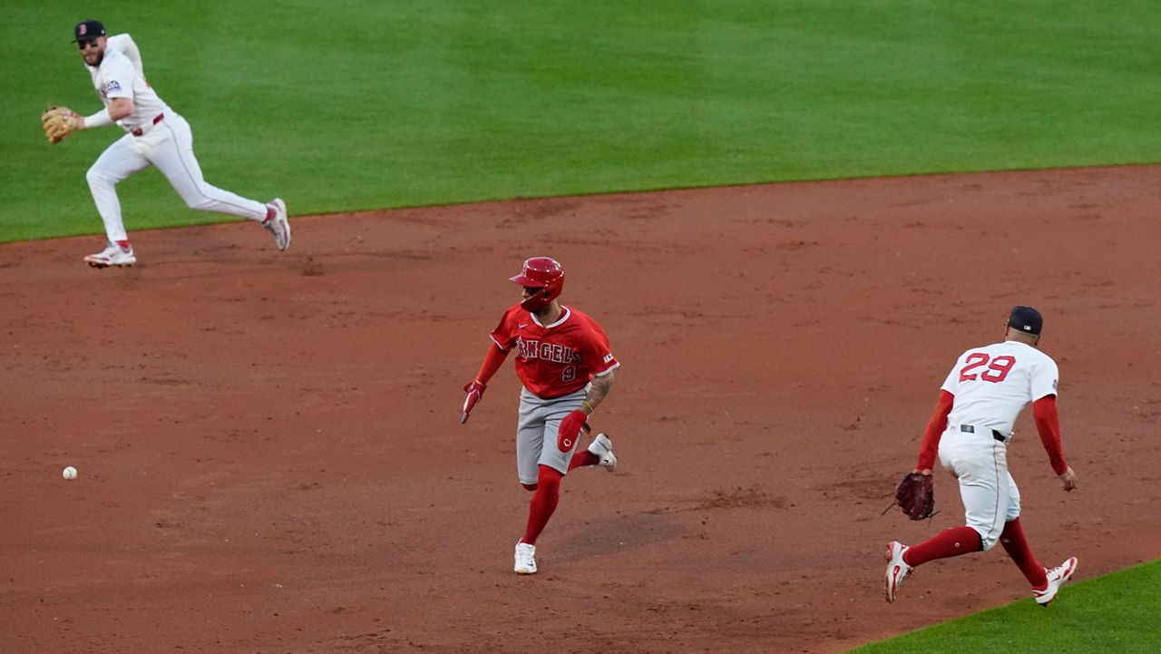 Los Angeles Angels' Zach Neto runs for home as a hit by Nolan Schanuel gets through Boston Red Sox third baseman Abraham Toro (29) and shortstop Trevor Story (10) in the third inning of a baseball game, Tuesday June 3, 2025, in Boston. (AP Photo/Robert F. Bukaty)