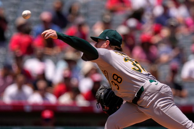 Athletics starting pitcher JP Sears throws to the plate during...