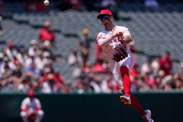 Angels shortstop Zach Neto throws out the Athletics’ Lawrence Butler...