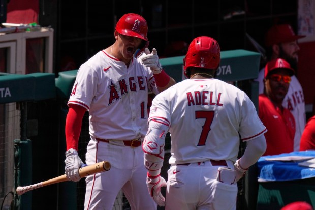 The Angels’ Jo Adell, right, is congratulated by teammate Kevin...