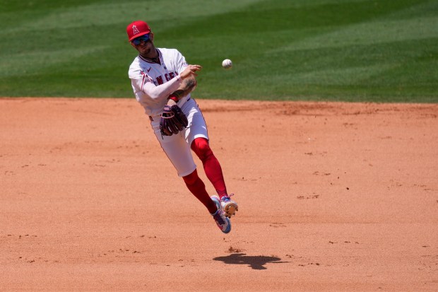 Angels shortstop Zach Neto throws out the Athletics’ Luis Urías...