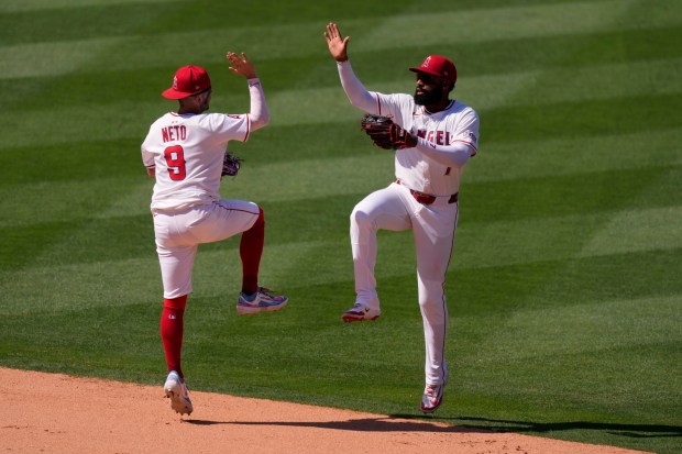 Angels shortstop Zach Neto, left, and center fielder Jo Adell...
