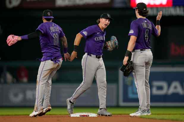 Colorado Rockies third baseman Orlando Arcia (11), left fielder Jordan Beck (27) and first baseman Michael Toglia (4) celebrate after winning a baseball game against the Washington Nationals at Nationals Park, Wednesday, June 18, 2025, in Washington. (AP Photo/Jess Rapfogel)