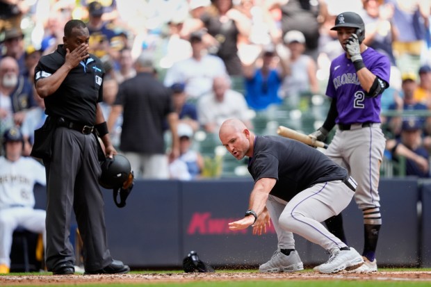 Colorado Rockies interim manager Warren Schaeffer, middle, gestures to an umpire after being ejected during the third inning of a baseball game against the Milwaukee Brewers, Sunday, June 29, 2025, in Milwaukee. (AP Photo/Aaron Gash)