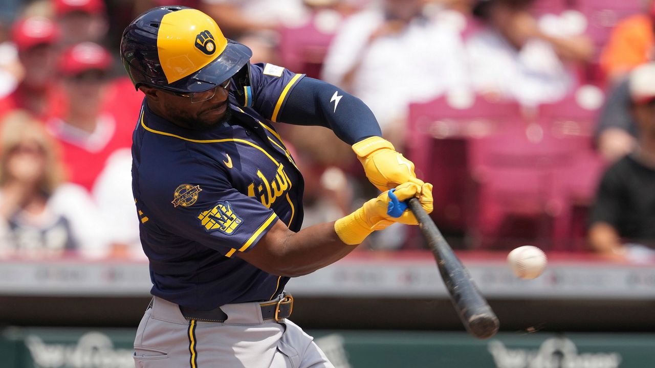 Cincinnati Reds' TJ Friedl catches a fly ball at the wall to end the game in the ninth inning of a baseball game against the Milwaukee Brewers, Tuesday, June 3, 2025, in Cincinnati. (AP Photo/Kareem Elgazzar)
