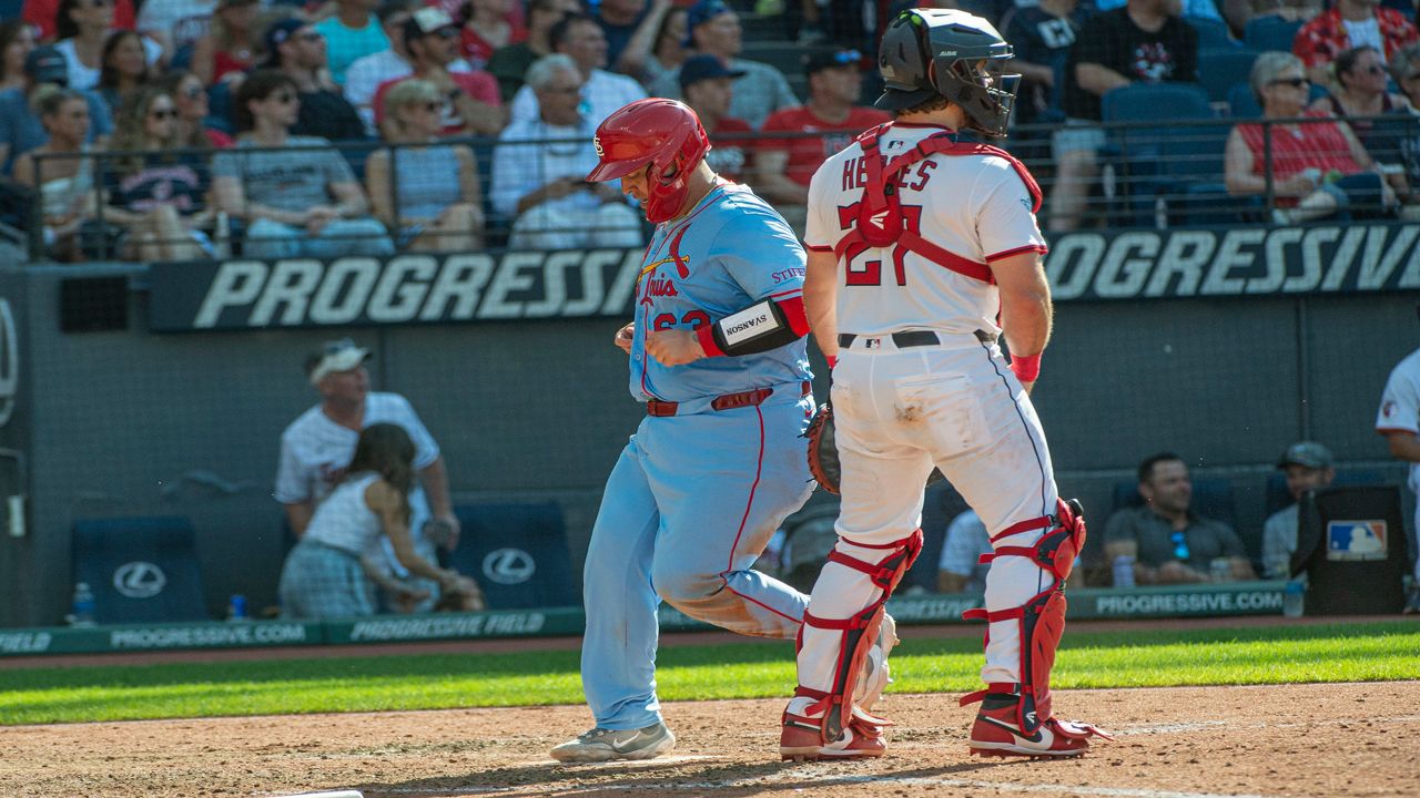 St. Louis Cardinals' Masyn Winn dives back into first base as the ball gets away from Cleveland Guardians first baseman Kyle Manzardo on a pickoff-attempt in the third inning of a baseball game in Cleveland, Friday, June 27, 2025.