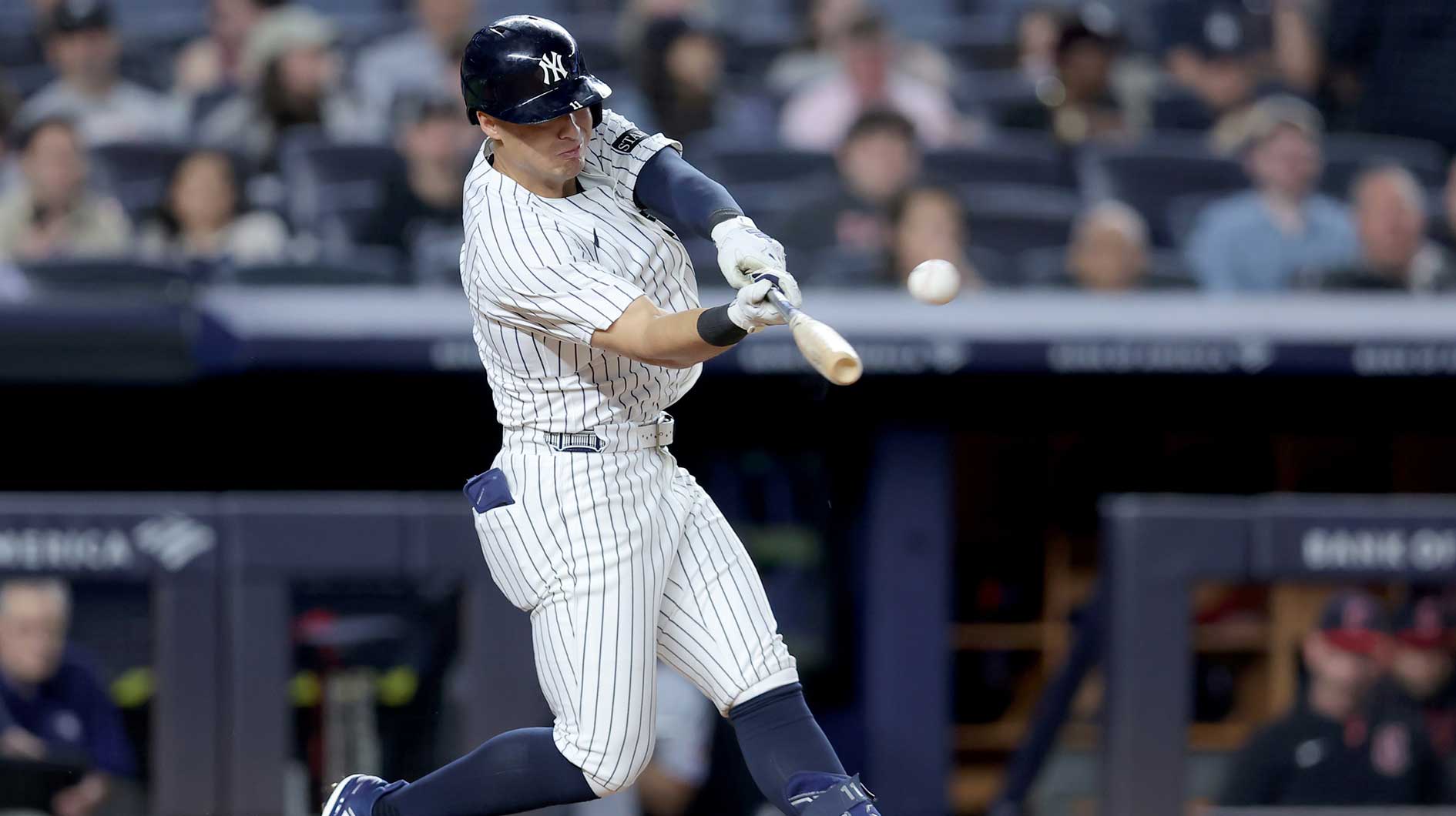 Jun 3, 2025; Bronx, New York, USA; New York Yankees shortstop Anthony Volpe (11) hits a solo home run against the Cleveland Guardians during the seventh inning at Yankee Stadium. 