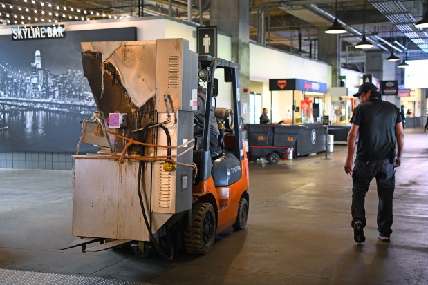 Stadium work crews remove a kitchen appliance that caught fire before the MLB game at Oracle Park in San Francisco, Calif., on Sunday, June 8, 2025. A grease fire near section 118 forced players to evacuate onto the field until it was cleared by officials. (Jose Carlos Fajardo/Bay Area News Group)
