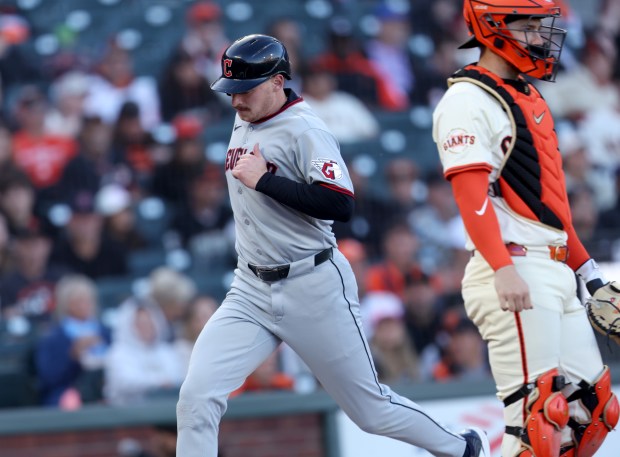 Cleveland Guardians’ Kyle Manzardo #9 scores past San Francisco Giants...