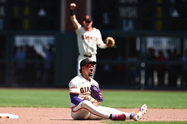 San Francisco Giants’ Willy Adames (2) celebrates after tagging out...