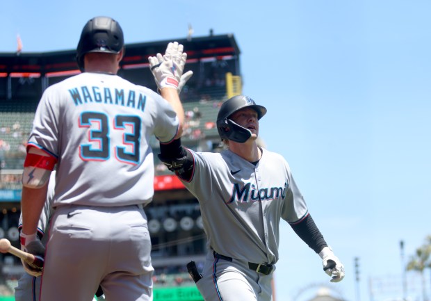 Miami Marlins' Kyle Stowers #28 is congratulated by teammate Eric Wagaman #33 after his three-run home run off San Francisco Giants starting pitcher Hayden Birdsong #60 in the first inning of their MLB game at Oracle Park in San Francisco, Calif., on Thursday, June 26, 2025. (Jane Tyska/Bay Area News Group)