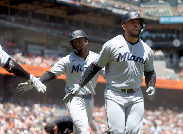 Miami Marlins' Agustín Ramírez #50 and teammate Jesús Sánchez #7...