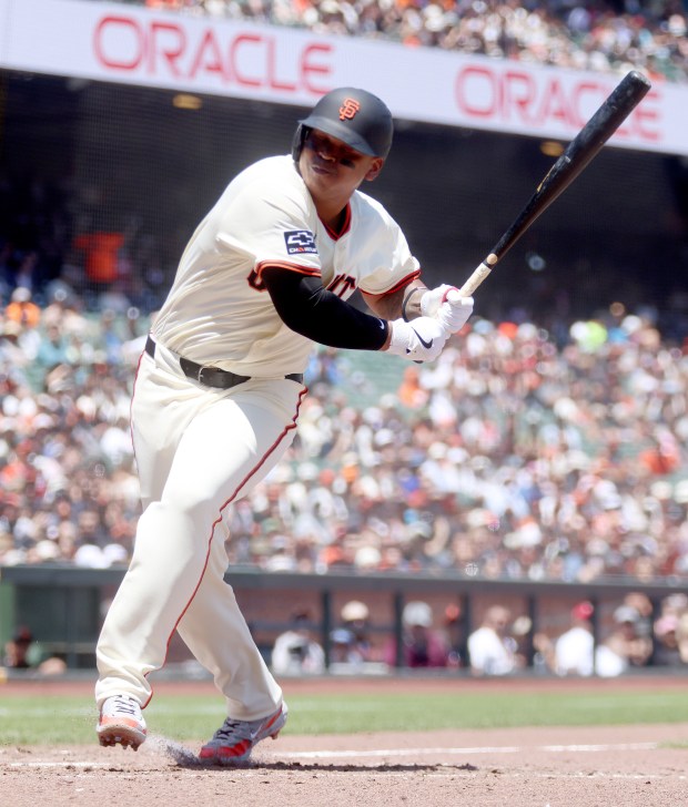 San Francisco Giants designated hitter Rafael Devers #16 gets turned...
