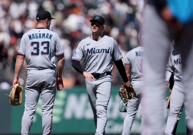 Miami Marlins' Kyle Stowers #28 and teammate Eric Wagaman #33...