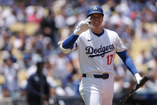 Los Angeles Dodgers' Shohei Ohtani gestures before his first at-bat during the first inning of a baseball game against the Washington Nationals in Los Angeles, Sunday, June 22, 2025. (AP Photo/Jessie Alcheh)