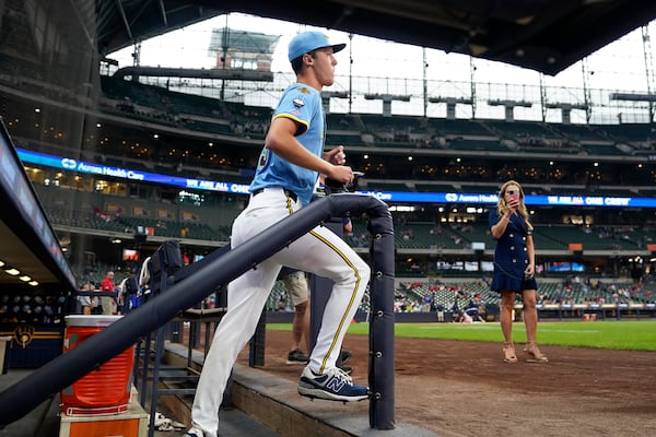Milwaukee Brewers pitcher Jacob Misiorowski, center, runs onto the field to warm up for his major league debut in a baseball game against the St. Louis Cardinals, Thursday, June 12, 2025, in Milwaukee. (AP Photo/Kayla Wolf)