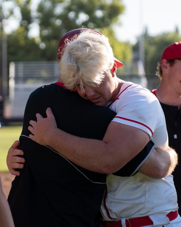 Chico High senior Luke Henderson, right, hugs Panthers' head coach...